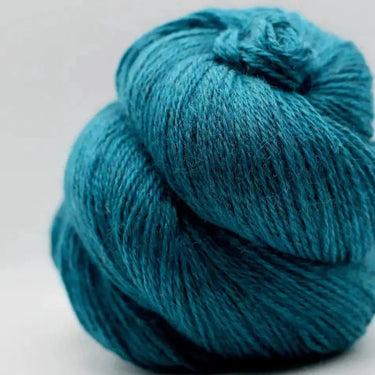 Yarnadelic Sport 100% Falklands Corriedale yarn in teal blue, perfect for knitting and crafting.