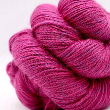 Pink skein of yarn on a white background