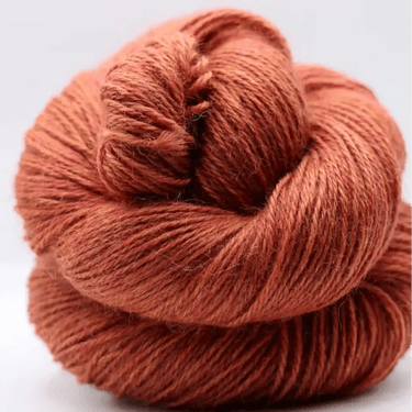 Yarnadelic Sport yarn in a warm color, showcasing its 100% Falklands Corriedale fiber.