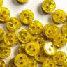 Yellow buttons with a textured surface on a white background