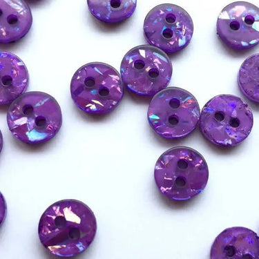 Purple iridescent buttons on a white background