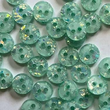 Green glittery buttons on a light background