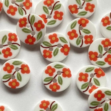 White buttons with floral designs on a white background