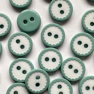 Pattern of green and white buttons on a light background