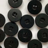 Pattern of black buttons on a white background