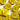 Close-up of yellow buttons with a glittery texture on a white background