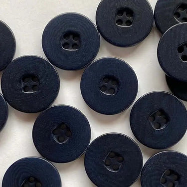 Pattern of dark blue buttons on a white background
