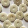 Multiple white buttons arranged in a grid on a light background