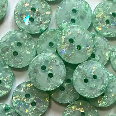 Green buttons with a glittery finish on a white background