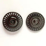 Two black metal pulleys on a white background