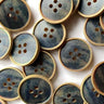 A collection of 20mm streaky blue wood buttons (J5) with a dark blue center, perfect for crafts and sewing projects.