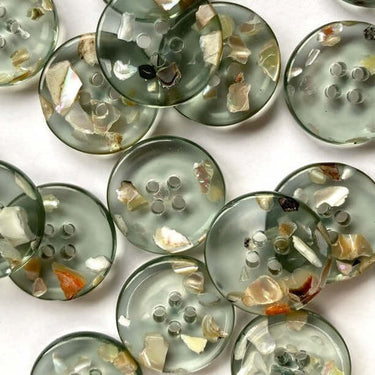 20mm transparent green embedded with real shell chips (K8) buttons showcasing shell chip design and glossy finish.