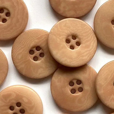 Close-up of wooden buttons on a white background