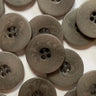 Pattern of brown buttons on a white background