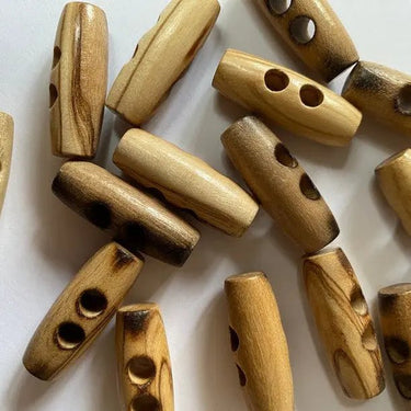 Wooden toggles with two holes on a white background