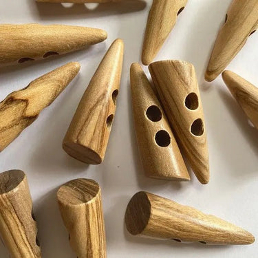 Wooden cones with holes on a white background