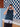 Person wearing a knitted sweater holding a camera, related to 52 Weeks of Sweaters pre-order knitting book publication.