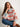 Woman wearing a colorful knitted sweater, featured in the 52 Weeks of Sweaters book.