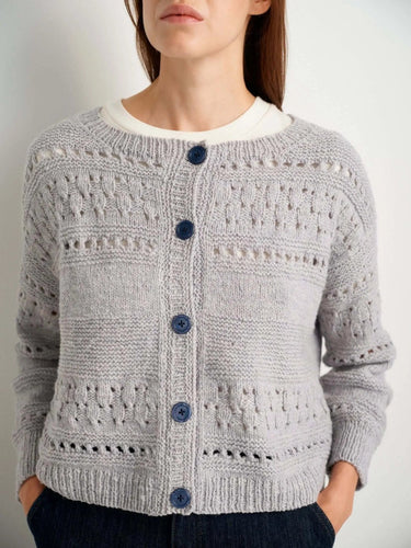 Model wearing gray cardigan featured in 52 Weeks of Sweaters knitting book pre-order
