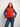 Model wearing a vibrant orange knitted sweater, featured in the 52 Weeks of Sweaters book available for pre-order.
