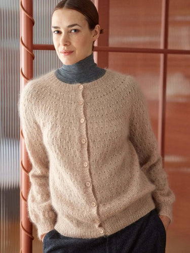 Model wearing a cozy sweater from '52 Weeks of Sweaters' knitting book, available for pre-order now.