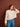 Woman modeling a knitted sweater from the 52 Weeks of Sweaters book, available for pre-order, with chevron pattern on brown background.