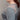 Woman wearing a light blue knitted sweater against a neutral background
