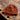 Brown knitted hat on a textured stone surface