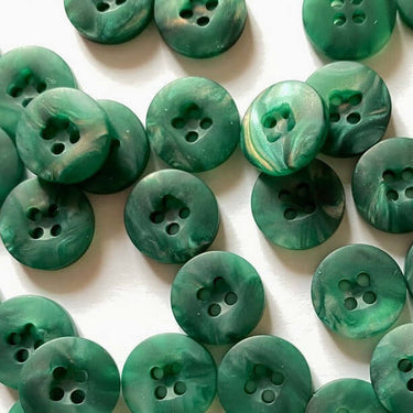 Green buttons with a marbled pattern on a white background
