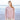 Model wearing a textured sweater from Aran by Marie Wallin collection on a beach background