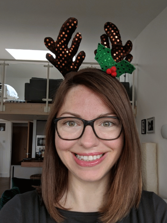Wool shop owner smiling with antlers 