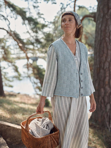 Woman enjoying nature wearing a knitted cardigan, promoting Laine Magazine Spring 28 pre-order.