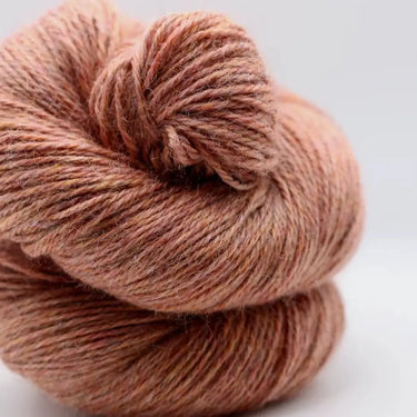 Close-up of Yarnadelic Sport wool skein made from 100% Falklands Corriedale, showcasing its texture and natural color.