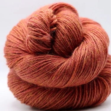 Yarnadelic Sport yarn in a warm color, showcasing its 100% Falklands Corriedale fiber.
