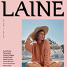 Cover of Laine Magazine Spring Issue 28 featuring a woman in a hat and knitted sweater on a boat.