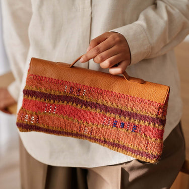 Person holding a clutch made with Beaded Colourwork knitting design, showcasing modern beaded knitting techniques.