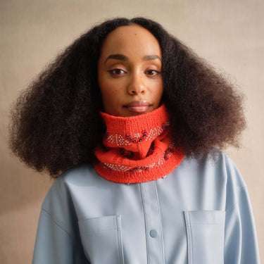 Model wearing a knitted cowl from 'Beaded Colourwork: A Modern Approach to Knitting with Beads' by Jeanette Sloan