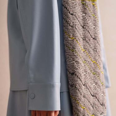 Beaded Colourwork knitting sample draped over a model's shoulder in stylish attire