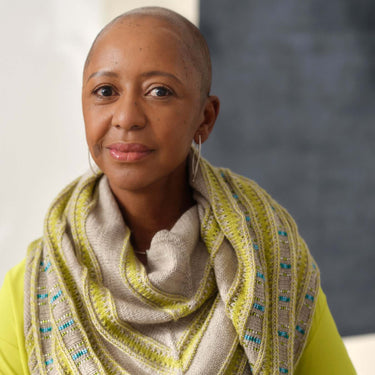 Woman wearing knitted scarf showcasing Beaded Colourwork style