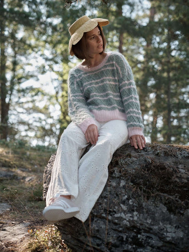 Model in knit sweater on rock, Laine Magazine Spring Issue 28 preview