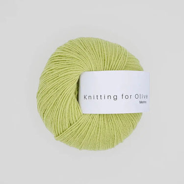 Knitting For Olive Merino yarn ball in light green color, ideal for cozy, breathable knit projects.