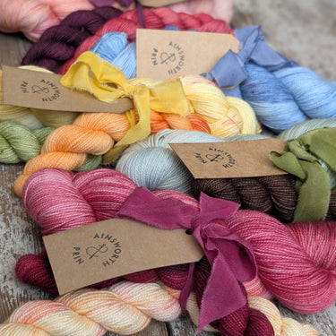 Ainsworth & Prin Flower Yarn Knitting Kits with colorful skeins tied with silk ribbons
