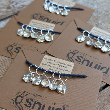 Handcrafted Silver Stitch Markers by Snuid displayed on cards