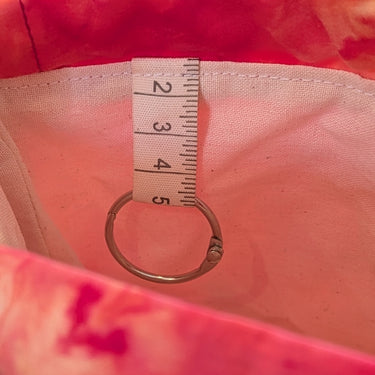 Close-up of Ice Dyed Project Knitting Bag - Small, showing ring for stitch markers and interior lining.