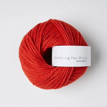 Red ball of Knitting for Olive Heavy Merino wool yarn with label.