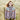 Woman wearing Aran by Marie Wallin designed Fairisle cardigan in field.