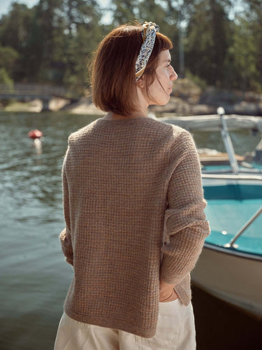Woman by the Baltic Sea wearing knit from Laine Magazine Spring Issue 28