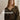 Model wearing a moss green cardigan from Jonna Helin's Mosspath collection