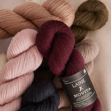 Collection of Laine x Novita DK yarn in various colors showcasing high-quality British fibres, ideal for double knitting projects.