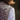 Person wearing a patterned vest with a blurred background